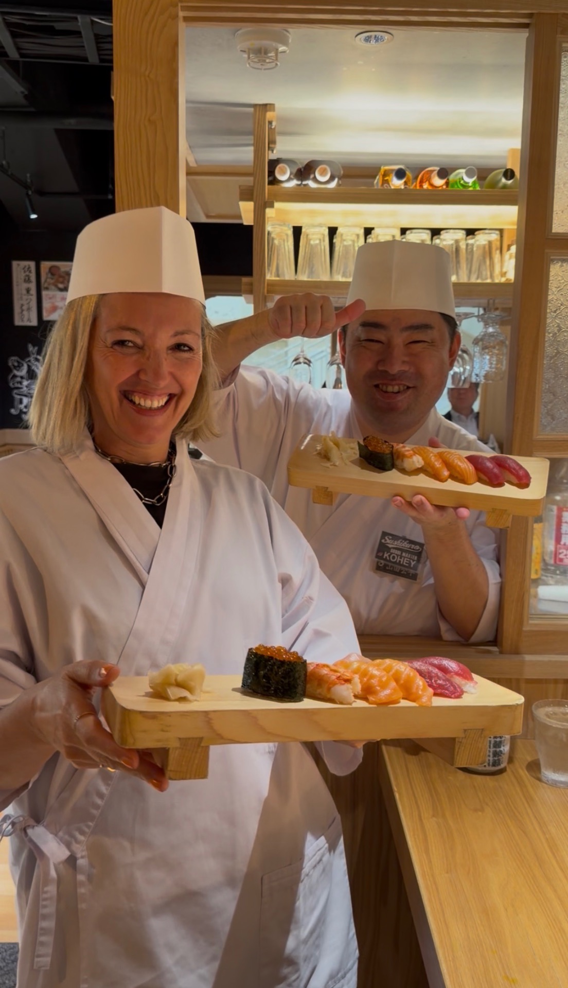 Nadine preparing sushi with a chef in Japan